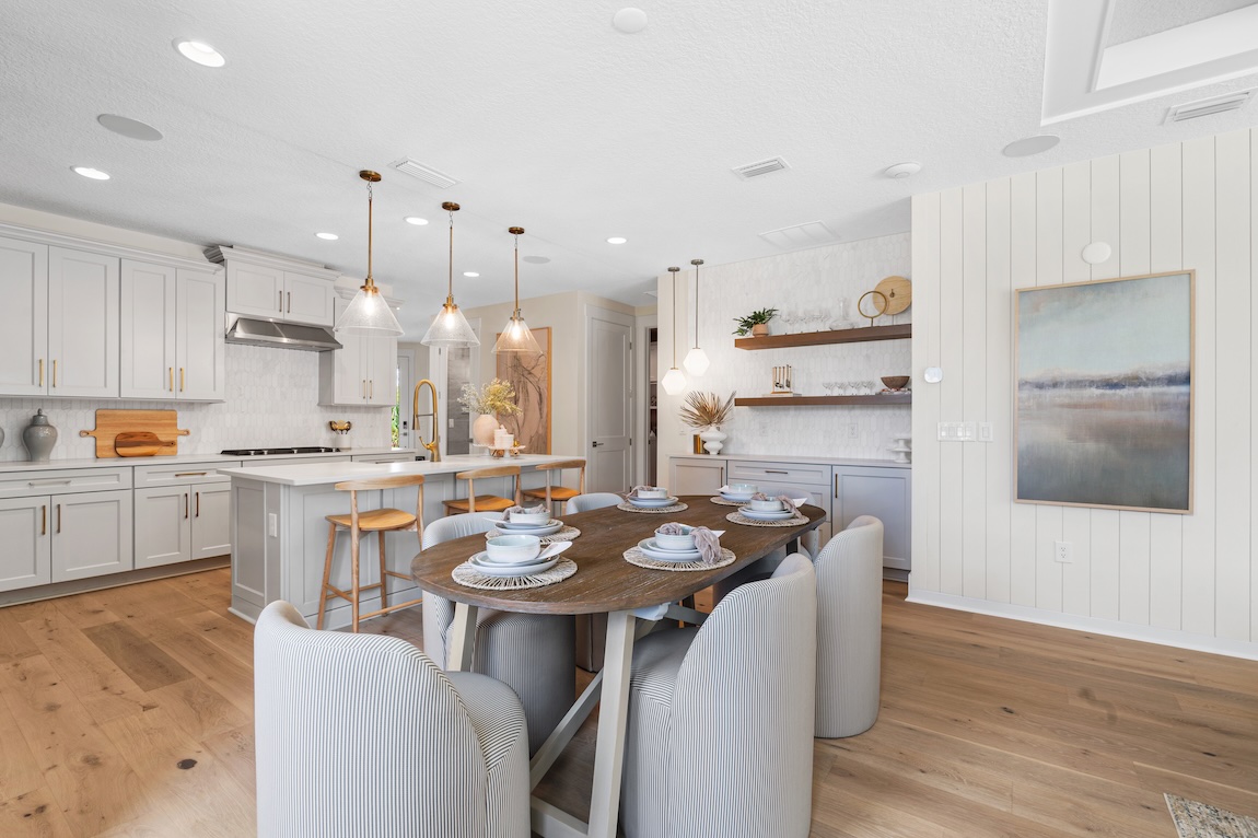 modern kitchen space with dining table and plush seating