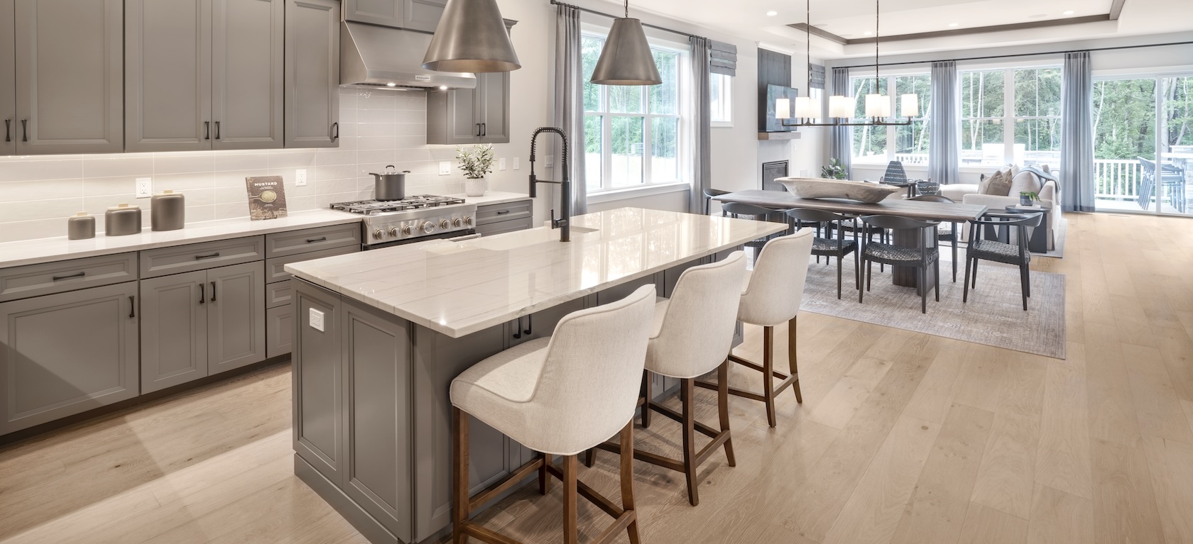 modern farmhouse kitchen with island and overhead lighting.