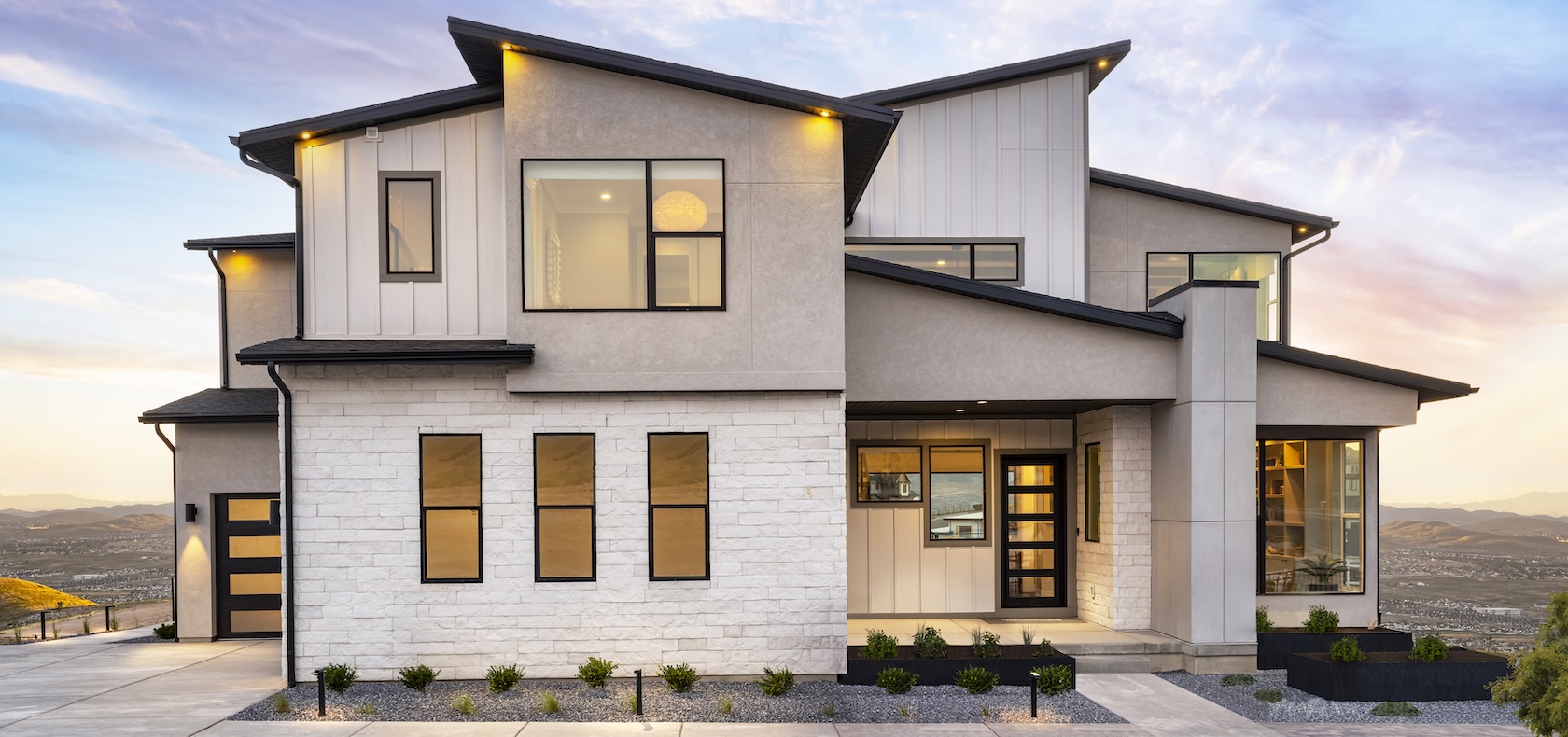 Exterior of two story home with large front windows.