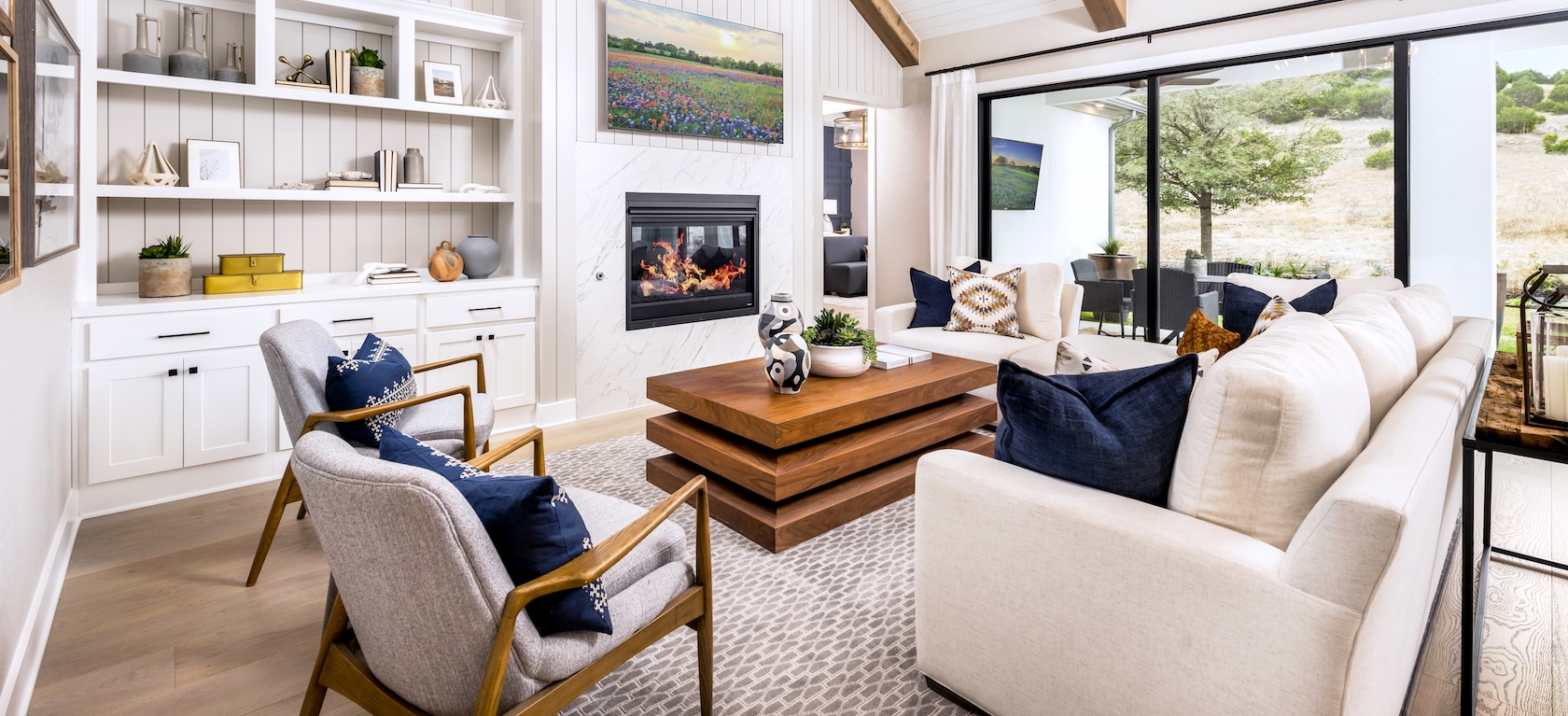 living room with large windows looking at outdoor living space.