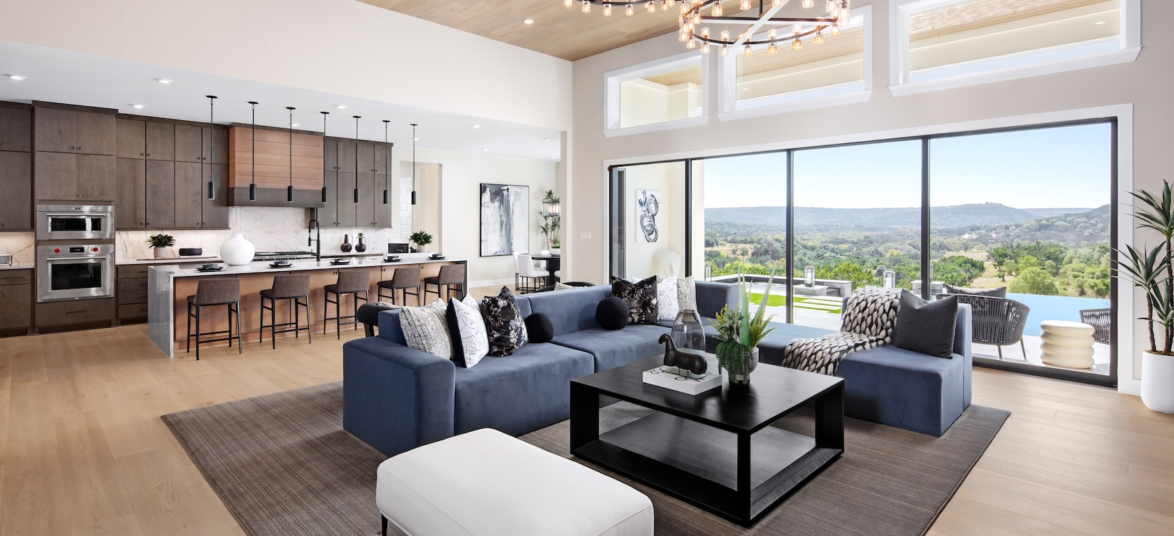 living room with overhead lighting and large windows