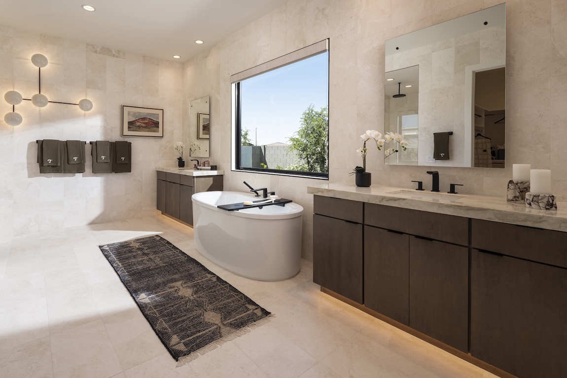 freestanding bathtub in front of large window