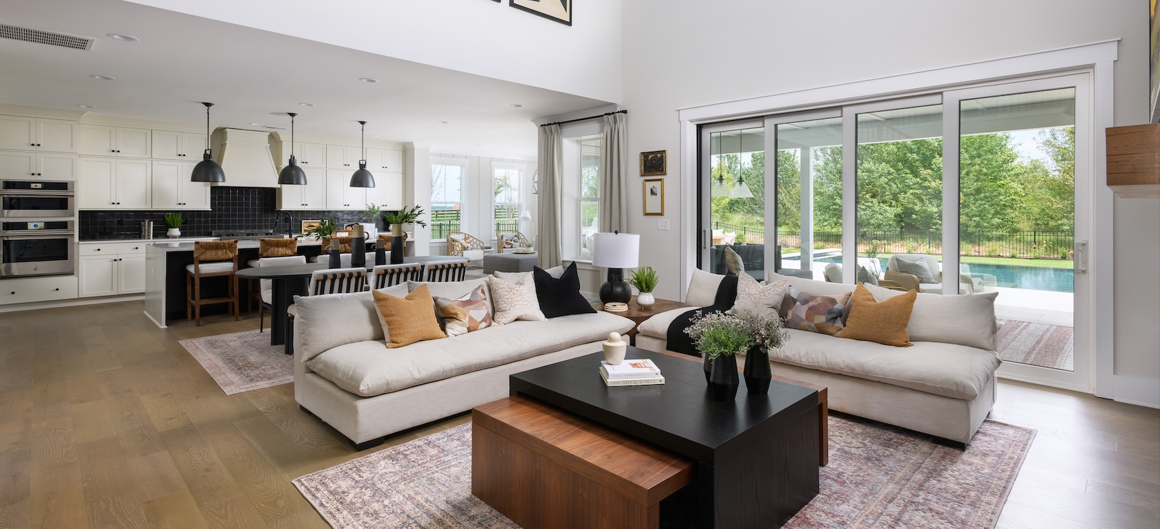 great room with high ceilings and glass sliding doors to the outdoor living space