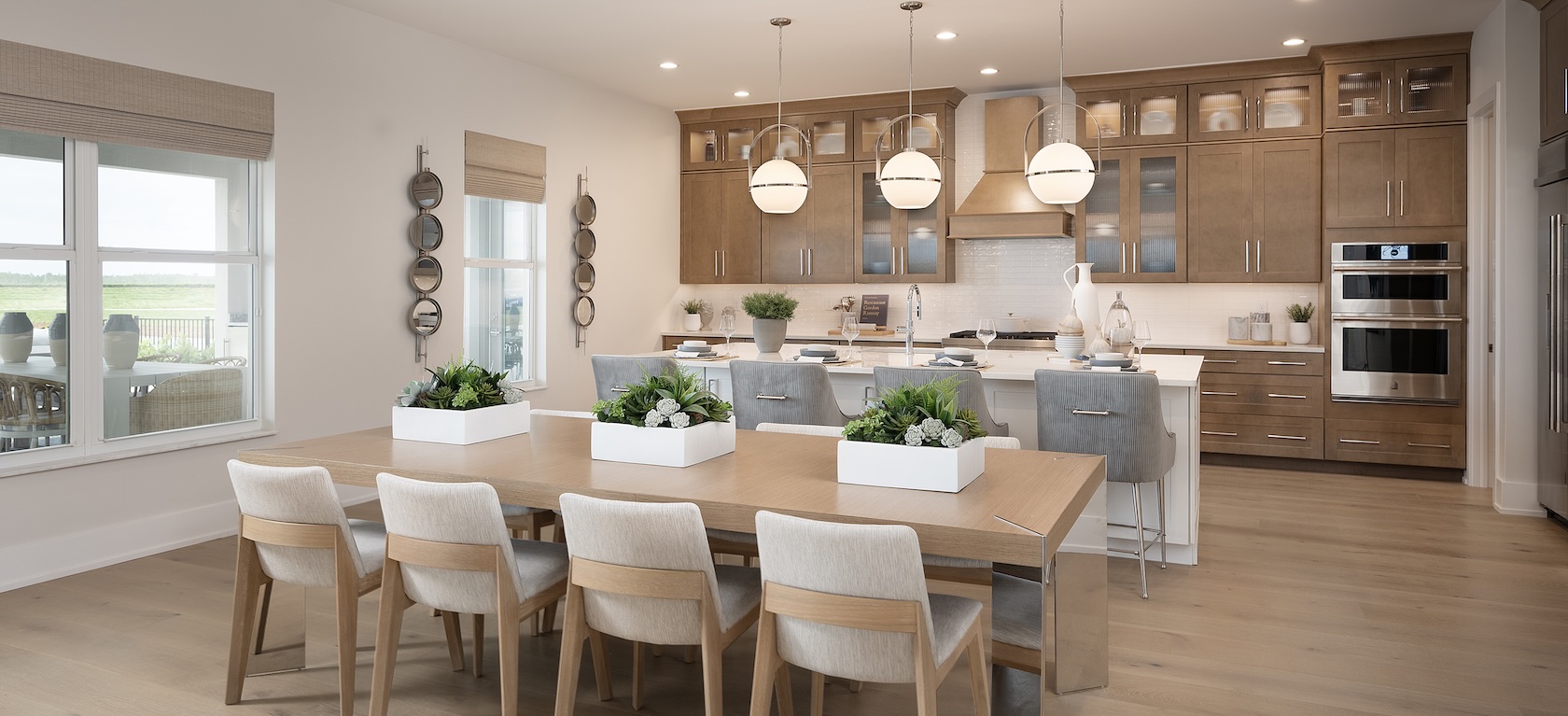 Spacious modern kitchen with natural wood cabinets and sleek island seating