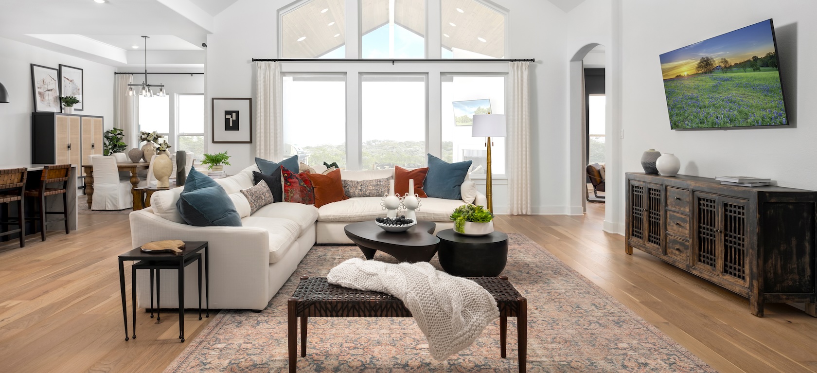 great room with high ceilings and seating areas