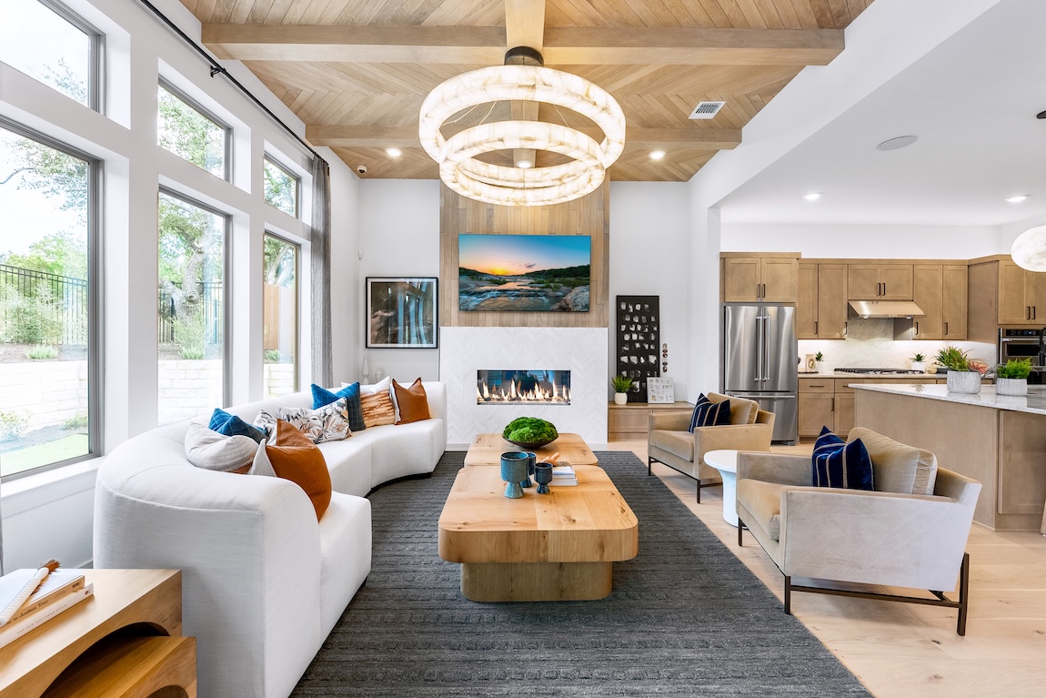 charming rustic living room adjacent the kitchen design within a home at Wildspring by Toll Brothers