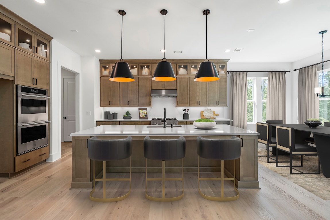 modern kitchen with wood cabinetry and black statement lights