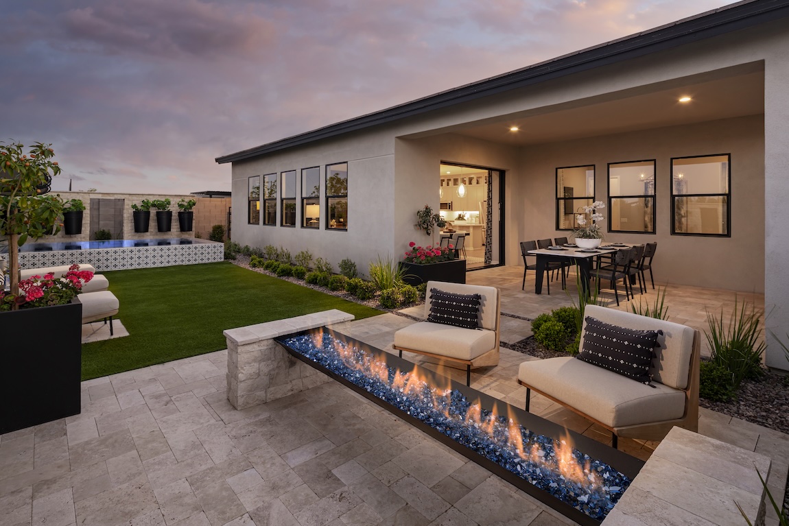 charming backyard design featuring linear fire pit and pool that Toll Brothers homeowners fall in love with