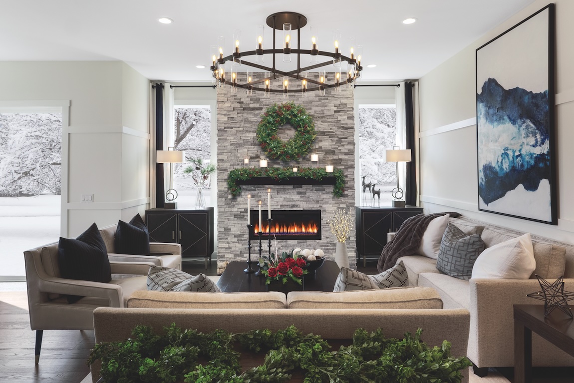 festive great room with charming stone fireplace and seasonal decor