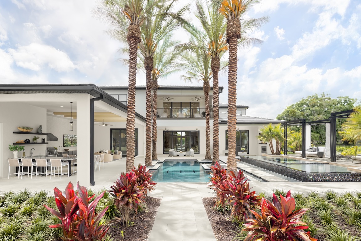 Luxe modern outdoor living design featuring outdoor kitchen, patio, and pool