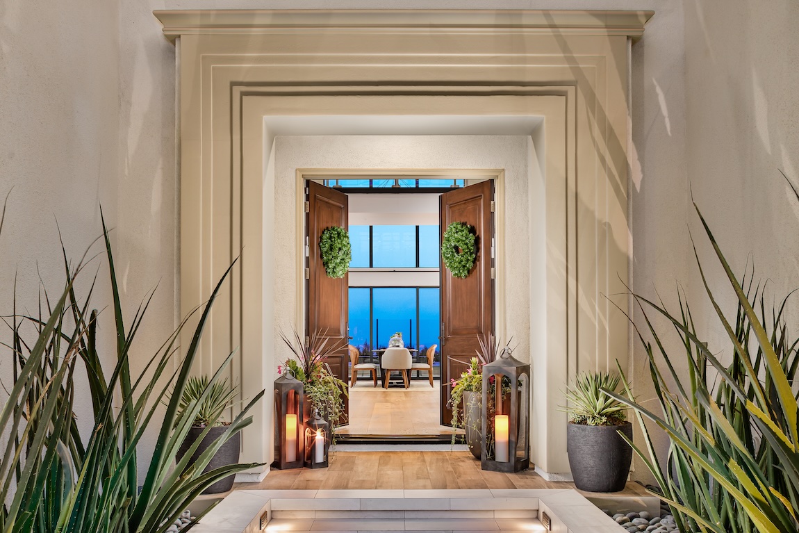 Stunning front door with decorative candles and seasonal greenery