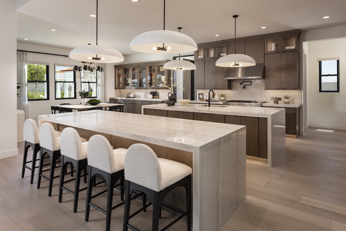 A dual-island kitchen design with breakfast nook