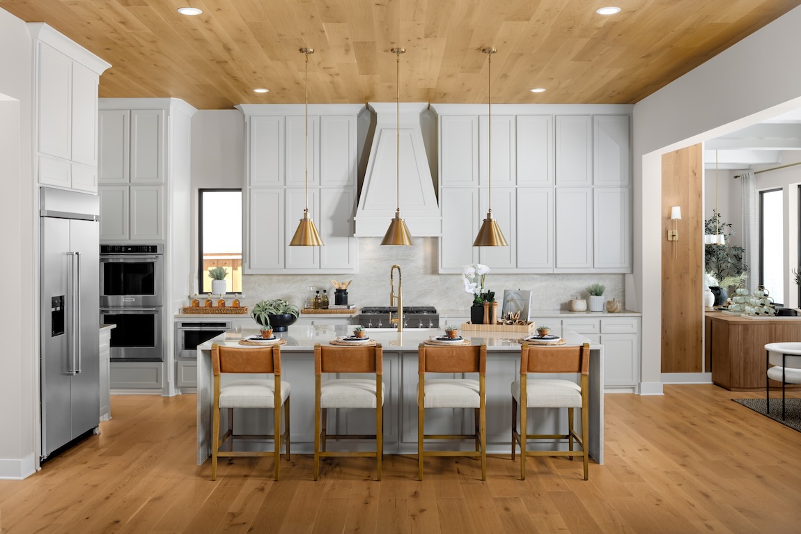 modern white kitchen design with gold and wood accents