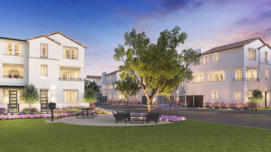 Luxury townhomes with landscaped park and modern outdoor seating at sunset.